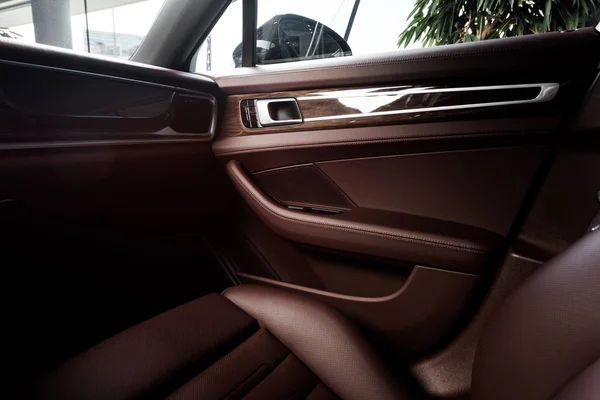 KYIV, UKRAINE - OCTOBER 7, 2019: selective focus of car door near brown leather car seat in porshe — Stock Photo