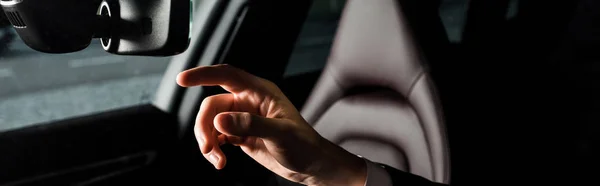 KYIV, UKRAINE - OCTOBER 7, 2019: panoramic shot of man pointing with finger at car mirror in porshe — Stock Photo