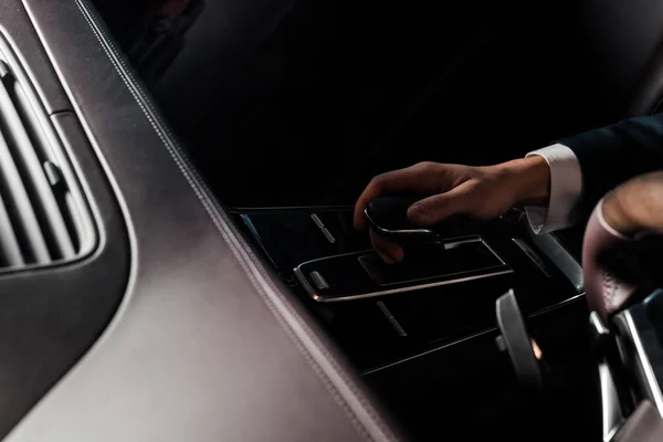 KYIV, UKRAINE - OCTOBER 7, 2019: selective focus of man touching gear shift in modern porshe — Stock Photo