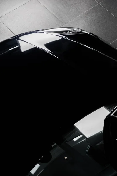 KYIV, UKRAINE - OCTOBER 7, 2019: top view of black and shiny porshe in car showroom — Stock Photo