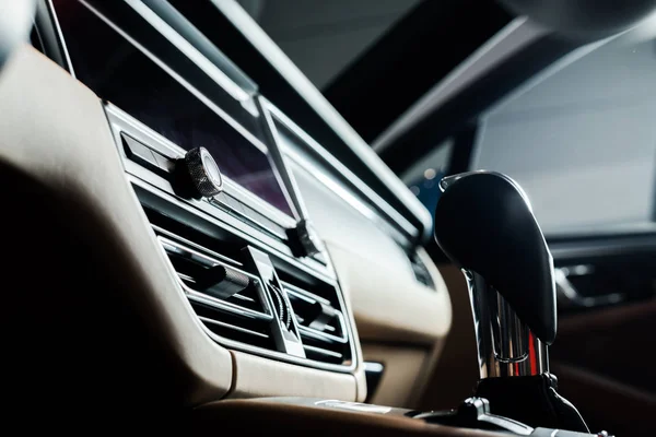 KYIV, UKRAINE - OCTOBER 7, 2019: selective focus of gear shift near air conditioner in new porshe — Stock Photo