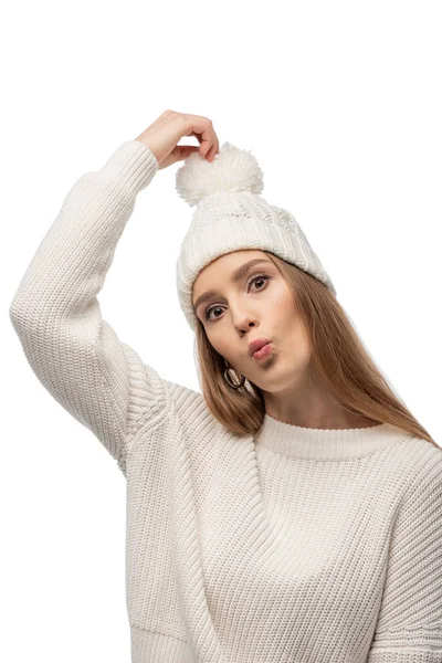 Attractive funny woman making grimace in white knitted sweater and hat, isolated on white — Stock Photo