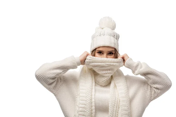 Attractive happy woman warming up in white knitted scarf, isolated on white — Stock Photo