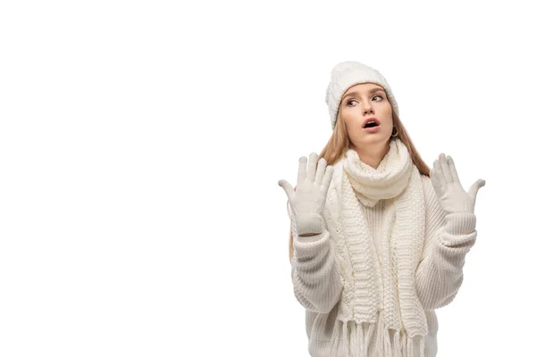 Dissatisfied young woman gesturing in white knitted clothes, isolated on white — Stock Photo