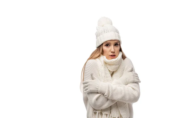 Beautiful worried woman warming up in white knitted clothes, isolated on white — Stock Photo