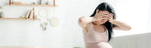 Panoramic shot of beautiful tired pregnant woman having headache in bedroom — Stock Photo