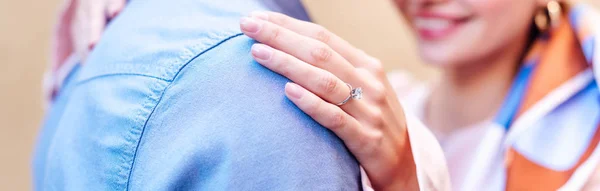 Cropped view of young woman in wedding ring embracing boyfriend — Stock Photo