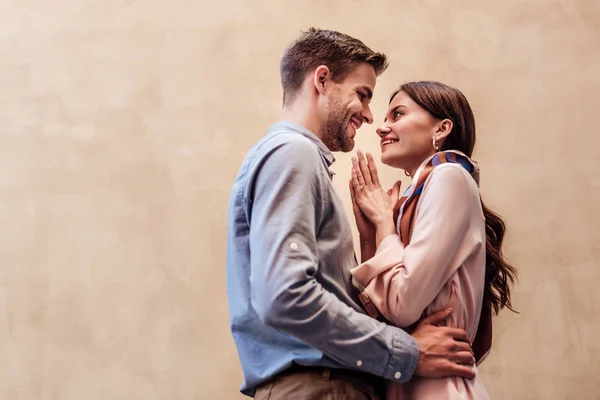 Happy young woman looking at boyfriend and showing please gesture — Stock Photo
