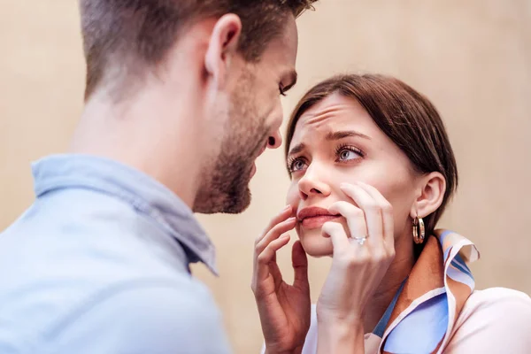 Attractive young woman imitating crying while looking at smiling boyfriend — Stock Photo