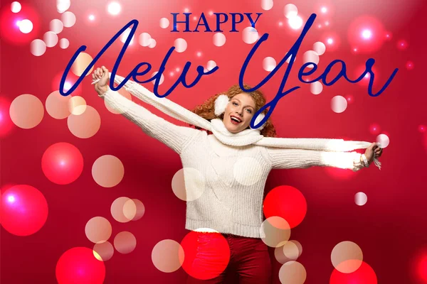 Beautiful cheerful woman posing in winter outfit on red with happy new year lettering — Stock Photo