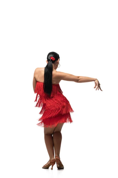 Back view of dancer in elegant dress with fringe performing tango on white background — Stock Photo