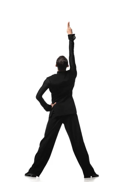 Vista trasera de bailarina en elegante traje negro realizando tango con mano sobre cadera sobre fondo blanco - foto de stock