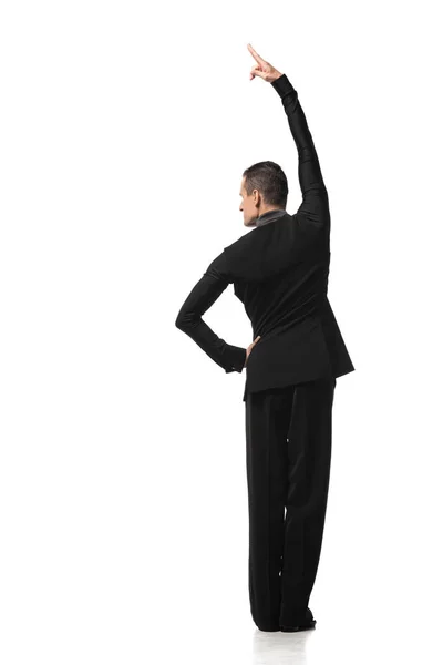 Back view of dancer in elegant black suit performing tango on white background — Stock Photo