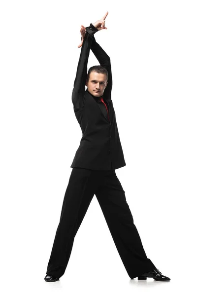 Handsome, passionate tango dancer in elegant black suit looking at camera on white background — Stock Photo