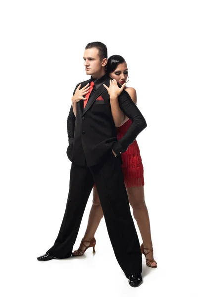 Sensual bailarina abrazando guapo, confiado compañero de espalda mientras realiza tango sobre fondo blanco - foto de stock