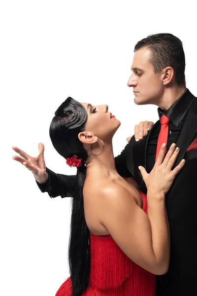 Passionate dancers looking at each other while performing tango isolated on white — Stock Photo