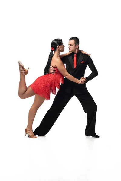 Passionate couple of dancers performing tango on white background — Stock Photo