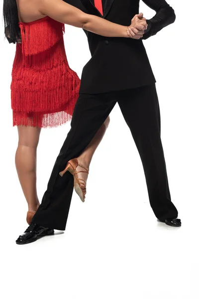 Cropped view of elegant dancers performing tango on white background — Stock Photo