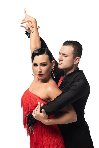 Attractive dancer looking at camera while performing tango with partner isolated on white — Stock Photo
