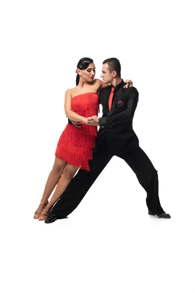 Élégant couple de danseurs exécutant le tango sur fond blanc — Photo de stock