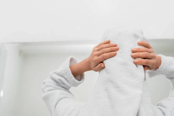 Back view of woman touching white towel in bathroom — Stock Photo