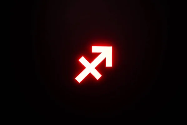 Signo zodiacal rojo iluminado de Sagitario aislado sobre negro - foto de stock