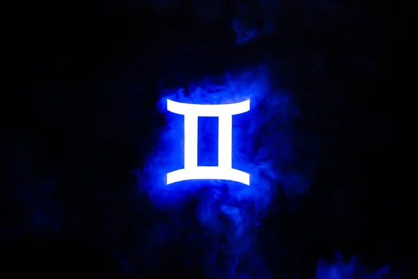 Blue illuminated Gemini zodiac sign with colorful smoke on background — Stock Photo