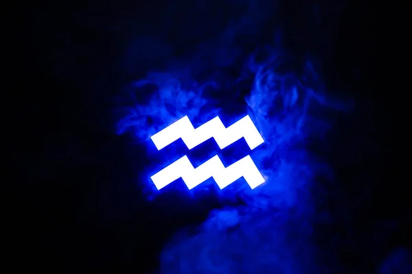 Blue illuminated Aquarius zodiac sign with smoke on background — Stock Photo