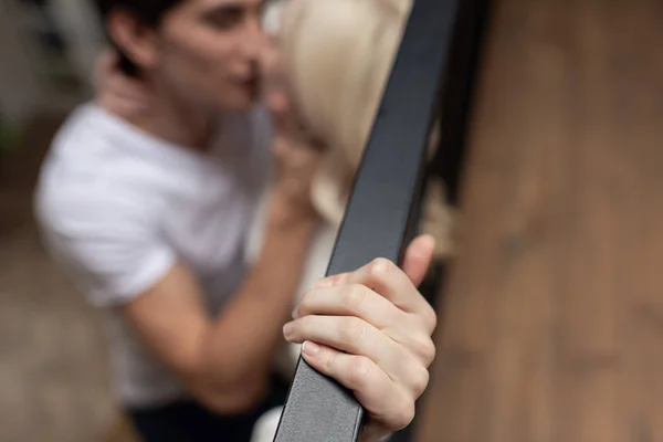 Selective focus of couple kissing by balcony railing — Stock Photo