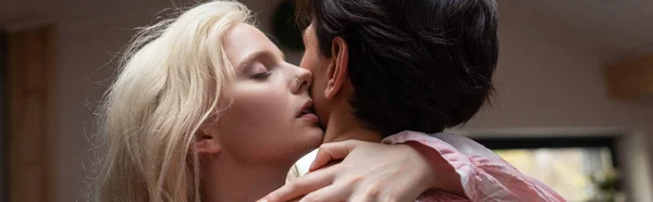 Blonde woman hugging shirtless boyfriend at home, panoramic shot — Stock Photo