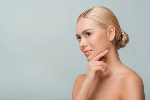 Happy naked woman touching face isolated on grey — Stock Photo