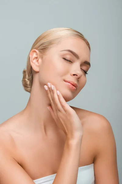 Beautiful woman touching clean face isolated on grey — Stock Photo