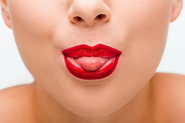 Cropped view of girl with red lips sticking out tongue isolated on white — Stock Photo