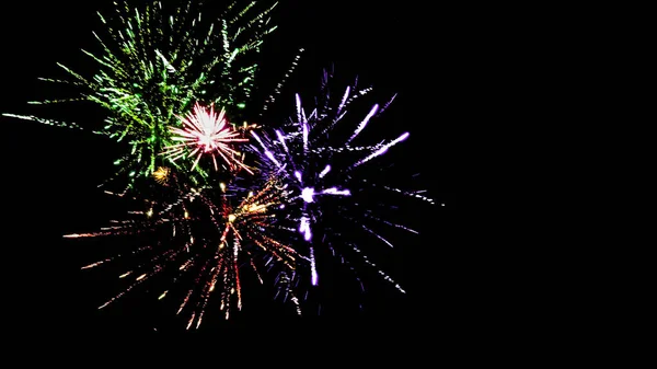 Colorful traditional fireworks in dark night sky, isolated on black — Stock Photo