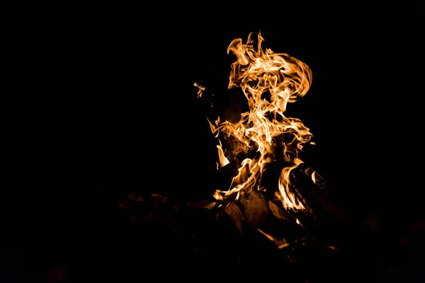 Logs burning in camp fire isolated on black — Stock Photo