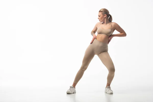 Twerk girl in beige leggings posing isolated on white — Stock Photo