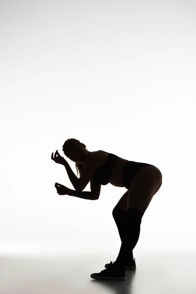 Silhouette of sexy girl twerking isolated on white — Stock Photo