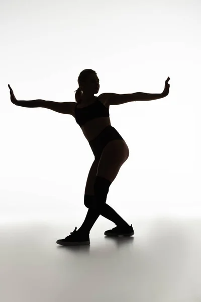Silhouette of sexy girl twerking isolated on white — Stock Photo