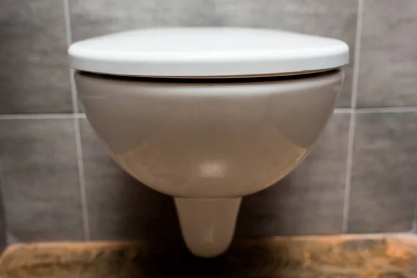 Close up view of ceramic clean toilet bowl with lid in modern restroom — Stock Photo