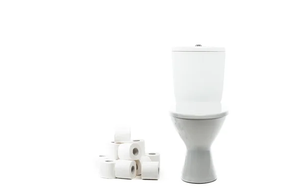 Ceramic clean toilet bowl near rolls of toilet paper isolated on white — Stock Photo