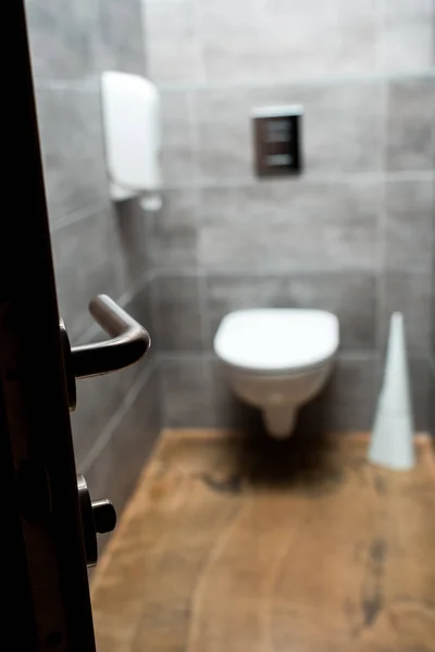 Selective focus of open door and grey modern restroom — Stock Photo