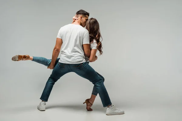 Back view of dancers dancing bachata on grey background with copy space — Stock Photo