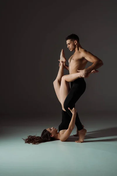 Sexy dancers dancing contemporary on dark background with copy space — Stock Photo