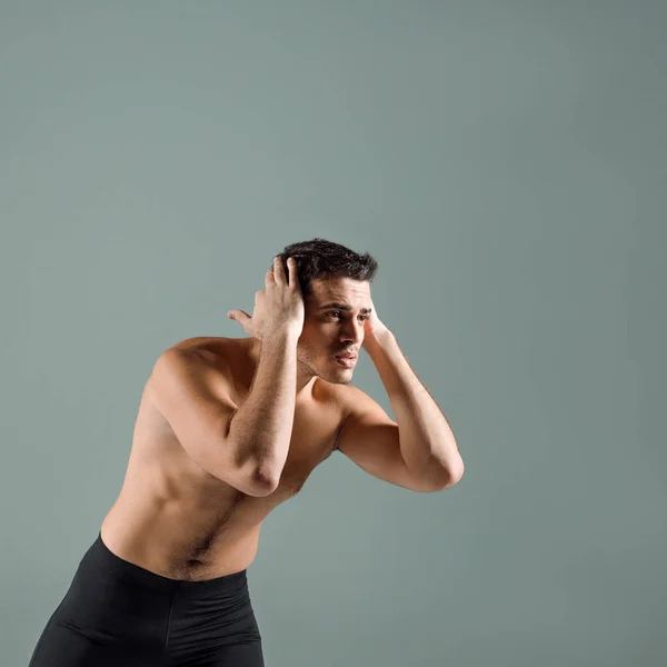 Handsome dancer in black leggings dancing contemporary isolated on grey — Stock Photo