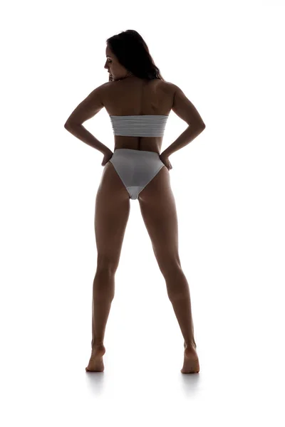 Vista posteriore di bella donna in biancheria intima bianca, isolato su bianco — Foto stock