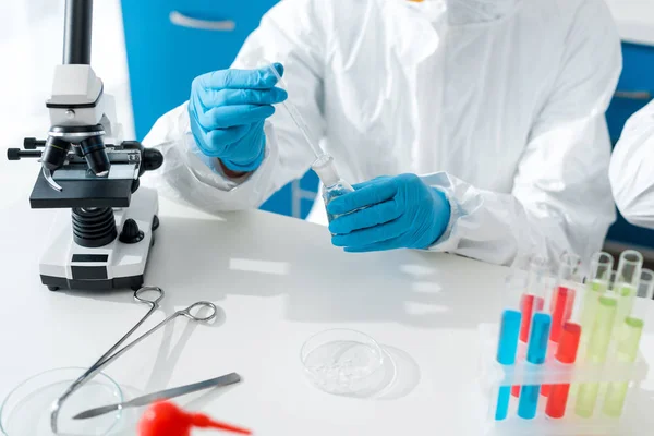 Обрезанный взгляд ученого, делающего тест ДНК в лаборатории — стоковое фото