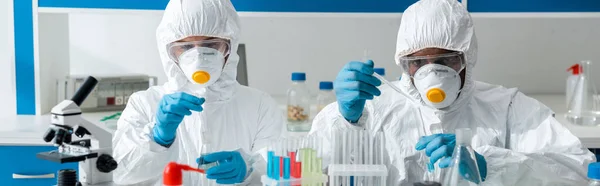 Panoramic shot of multicultural scientists doing dna test in lab — Stock Photo