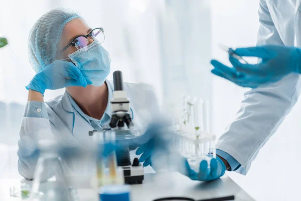 Selective focus of biologist looking at her african american colleague — Stock Photo