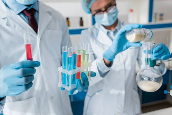 Cropped view of biologists doing test in lab — Stock Photo