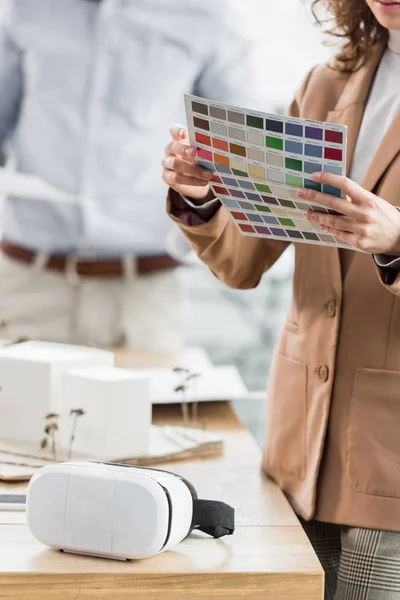 Cropped view of virtual reality architect holding layout of colors — Stock Photo